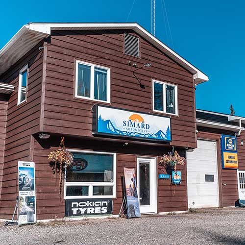 Simard Automotive shop with tire advertising signs.